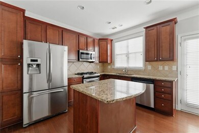 Kitchen featuring light stone countertops, applian