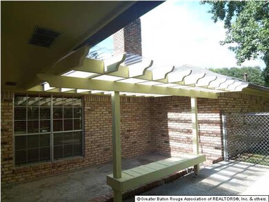 Rear patio...has a covered area as well as an open