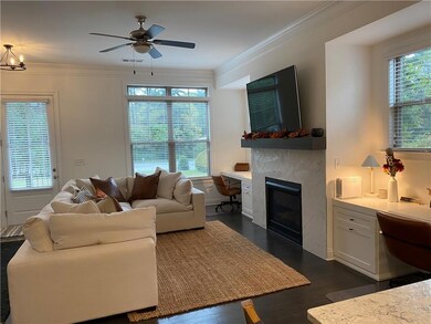Living room featuring dark wood-style flooring, a 