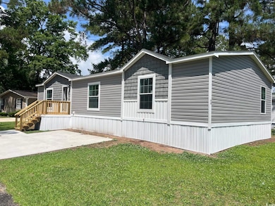 View of property exterior with a yard