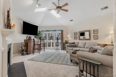 Living room featuring ornamental molding, light ca