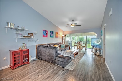 Living area featuring vaulted ceiling, ceiling fan