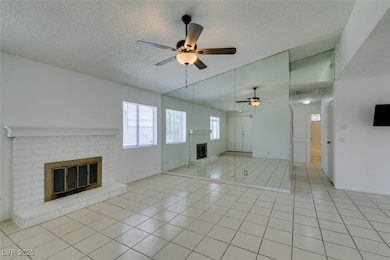 Unfurnished living room with a brick fireplace, ce