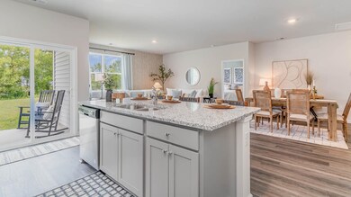 Kitchen with a sink, light stone countertops, stai