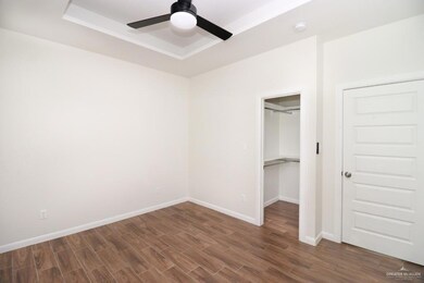 Unfurnished bedroom featuring a closet, ceiling fan, and dark hardwood / wood-style flooring