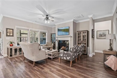Living room with a warm lit fireplace, visible ven