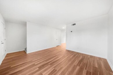 Spare room featuring baseboards, light wood-style flooring, and recessed lighting
