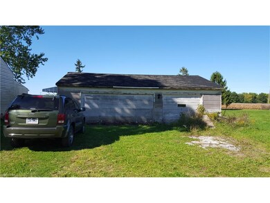 3 1/2 car detached garage with work tables and ele