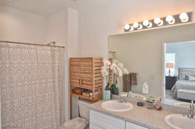 Full bath featuring ensuite bath, a sink, a shower