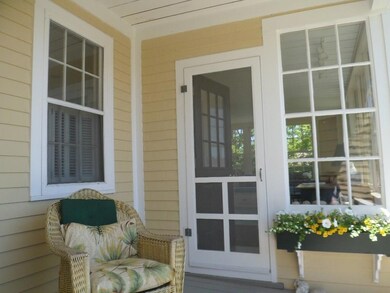 Covered front porch with door into...