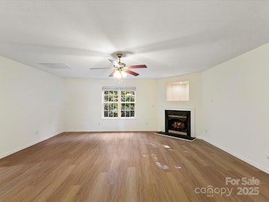 The spacious den features a fireplace