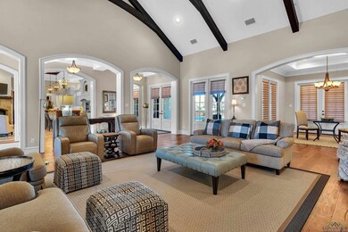 Living room featuring beam ceiling, high vaulted c