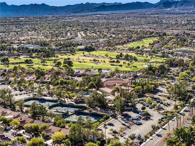 Aerial perspective of suburban area with a local golf course and mountains