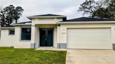 Prairie-style house with a garage and a front lawn