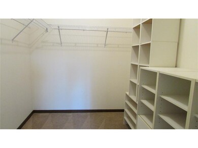 Large walk-in closet with built-in storage off the