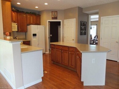 Kitchen has cherry cabinets and solid surface coun