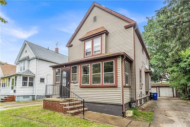 View of front of property featuring an outdoor structure and a garage