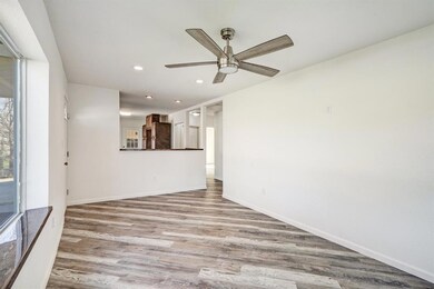 Living room with new flooring, ceiling fan and lot
