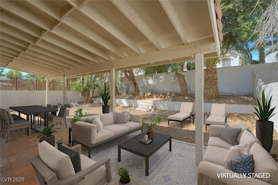 Fenced backyard with a patio area, an outdoor hangout area, and outdoor dining area