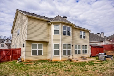 Rear view of house with a patio and a chimney