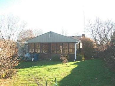 Exterior Back. Screened in sun room over looks all