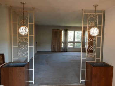The home has the original wrought iron trellis beh