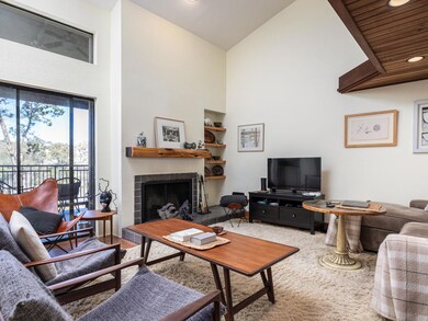 Living area with a high ceiling, built in feature