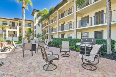 View of patio with a grill