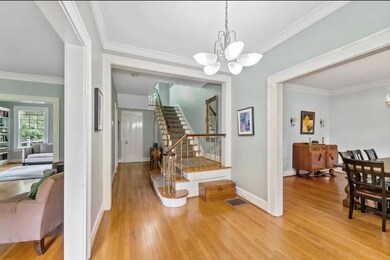 Entryway featuring an inviting chandelier, crown m