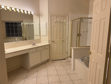 Bathroom with vanity, light tile patterned flooring, a bath, and a stall shower
