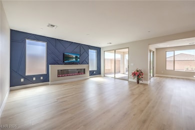 Unfurnished living room with light wood-style floo