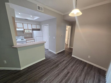 Kitchen with white appliances, baseboards, dark w