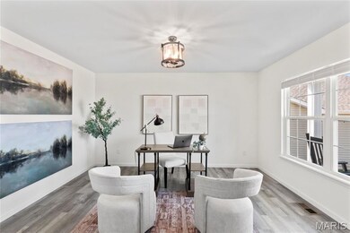 Office with wood finished floors and baseboards