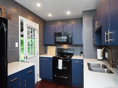 Wonderful Kitchen with tile walls and plenty of storage.