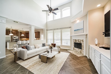 The two story windows in the family room provide t