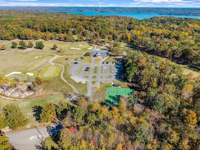 Drone / aerial view of a golf club and a nearby body of water