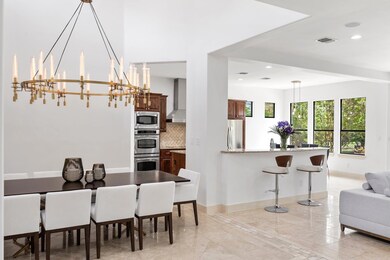 Dining space with a chandelier and recessed light