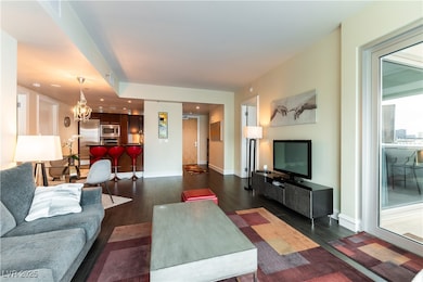 Living room with dark wood-style floors, baseboard