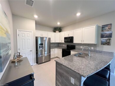 Kitchen featuring black appliances, kitchen penins