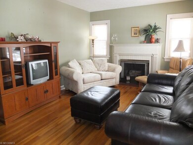 Living room with hardwood floors and fireplace.