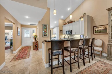 Kitchen with a breakfast bar, dark countertops, st