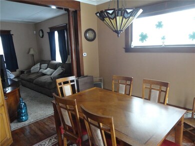 The dining room  offers wood floors, oak woodwork and trim and lots of natural light.