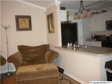 family room looking into the kitchen with bar that you can put stools under or just have a bar to use as a island for cooking.