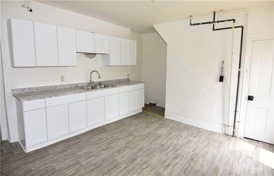 Kitchen features updated countertops, sink, and ca