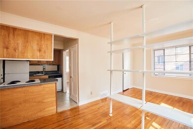 Kitchen featuring white appliances, dark counterto