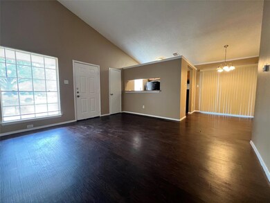 Unfurnished living room with a chandelier, wood f