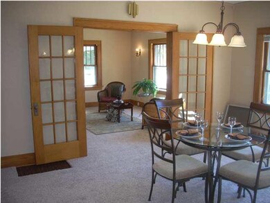 Formal dining room with french doors looking into 