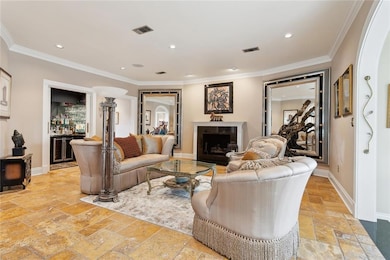 Greatroom: Gorgeous, wood burning fireplace trimmed in marble Marble mantle has fluted casings Open view to solarium Full wet bar with marble countertops & icebox Separate wine closet