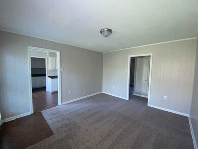 Unfurnished room featuring dark tile patterned flo