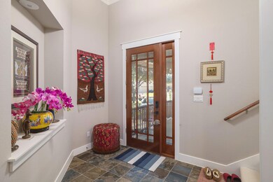 The foyer opens with natural light and a clear view toward the main living space